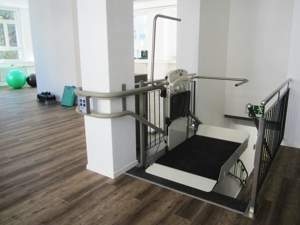 Platform lift in a rehabilitation facility promoting handicap accessibility and mobility aid support.