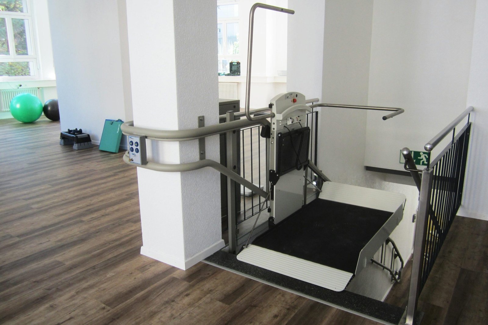 Platform lift in a rehabilitation facility promoting handicap accessibility and mobility aid support.